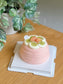 Top view of a guava cream and red grape cake decorated with guava pieces and white cream