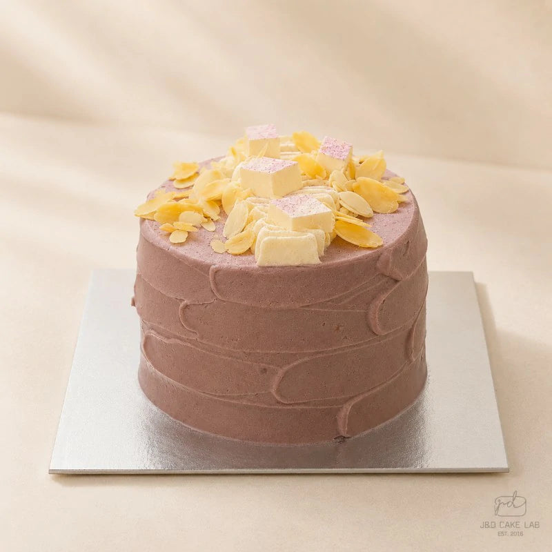 ide view of purple taro cheese lava cake with textured cream finish