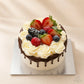 Top view Chocolate strawberry cream cake with a chocolate collar and fresh berries in Adelaide