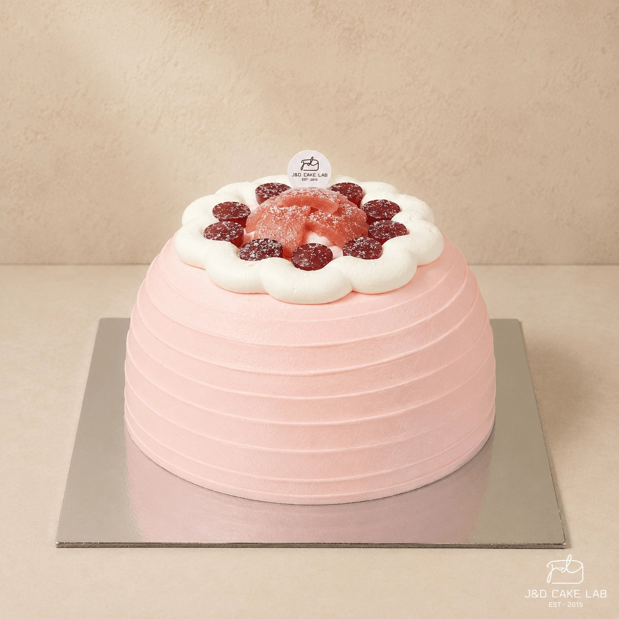 Blush guava cream and red grape cake with a pink textured finish in Adelaide