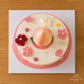 Top view of a Chinese ‘Longevity Peach’ Cake decorated with pink flowers, pearls and gold leaf