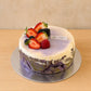Side view of handmade taro and ube burnt cheesecake with berry topping at J&D Cake Lab Adelaide