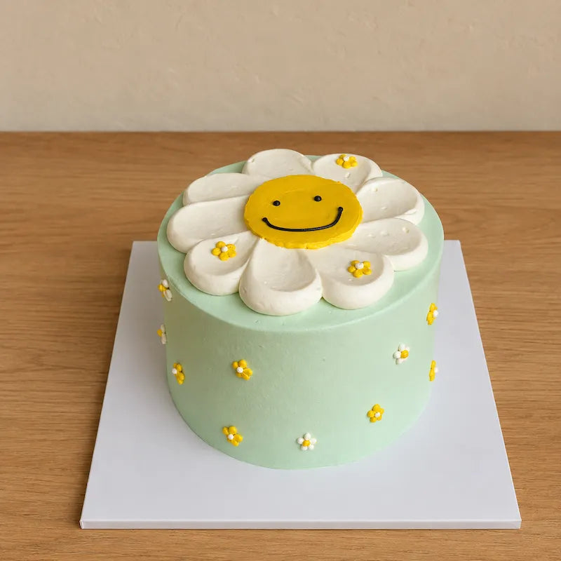 Side angle of mint green Daisy Smiley Face Cake with piped floral decorations