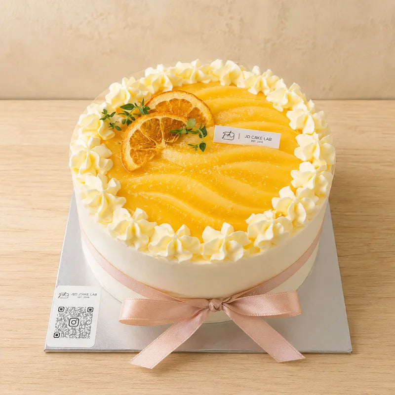 High-angle view of Lemon Yuzu Cream Cake with bright lemon topping, piped cream and dried citrus slices