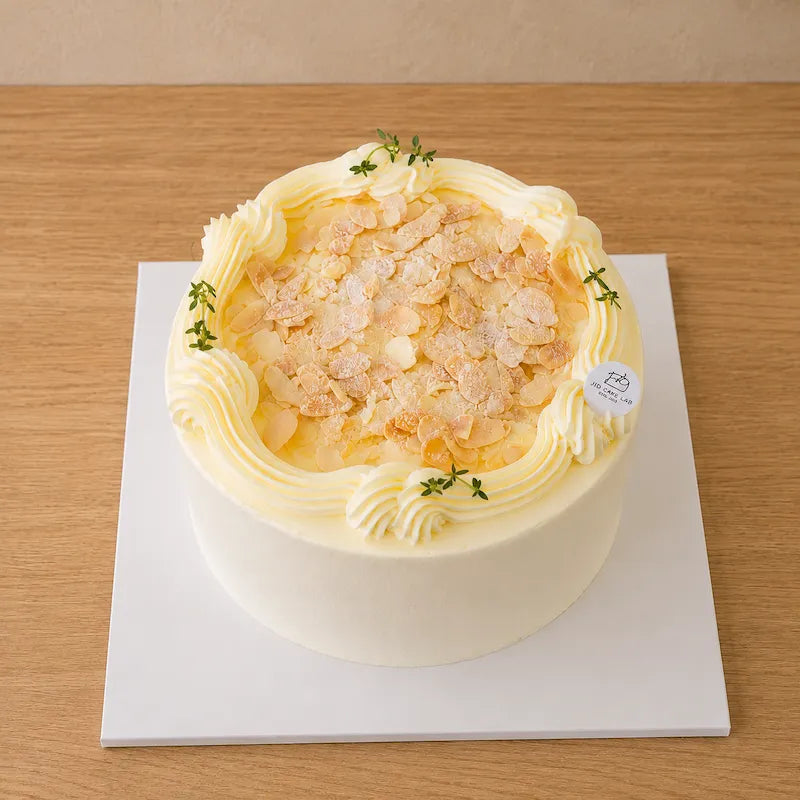 High-angle view of Trio Musang King Durian Cream Cake topped with almond flakes