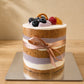 Close-up of Taro Naked Cake showing exposed chiffon and taro cream layers through the clear cake collar