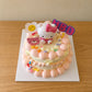 High-angle view of Vintage Hello Kitty Birthday Cake with character topper and pastel birthday decorations