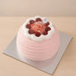 Front view of a pink guava cream cake with horizontal texture and red grape topping