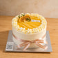 Front view of Lemon Yuzu Cream Cake with smooth cream finish, citrus topping and ribbon detail