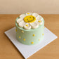 Top view of Daisy Smiley Face Cake with smiling flower design and mini daisy details
