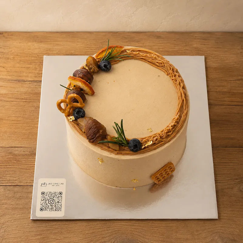 Close-up of chestnut cream piping and decorative toppings on a classic chestnut cake