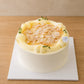 Three-quarter view of Musang King durian cream cake with smooth cream finish and almond topping
