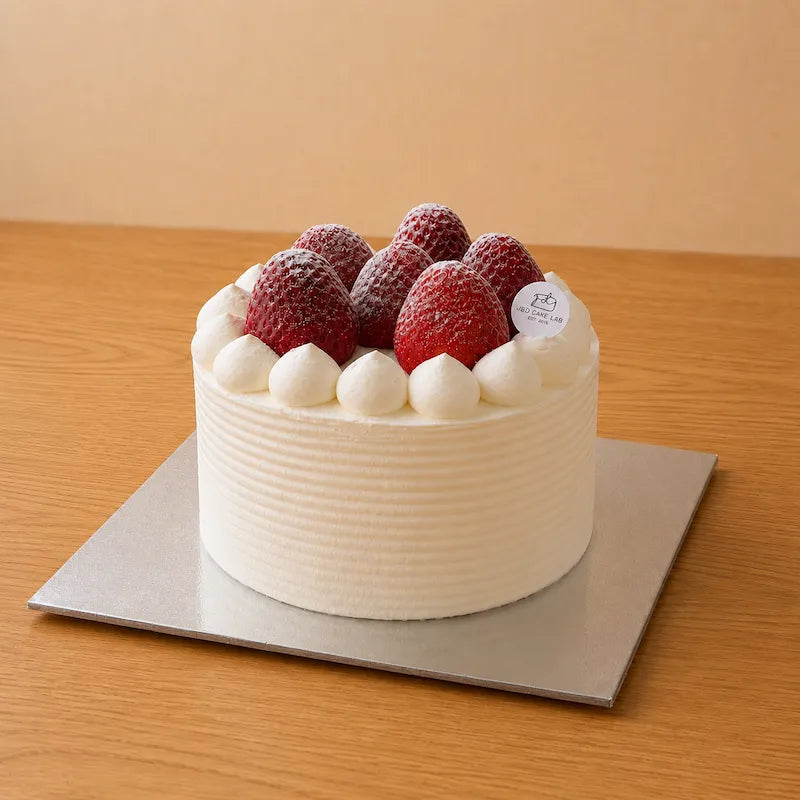 Three-quarter view of Japanese Style Strawberry Cream Cake topped with whole strawberries