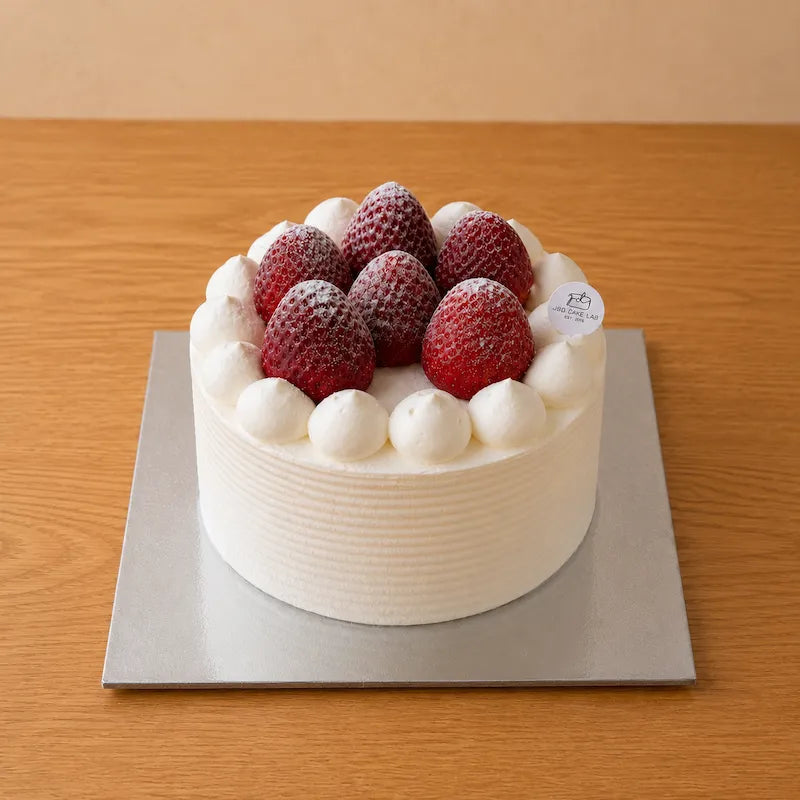Side-angle view of Japanese strawberry cream cake with a textured fresh cream finish