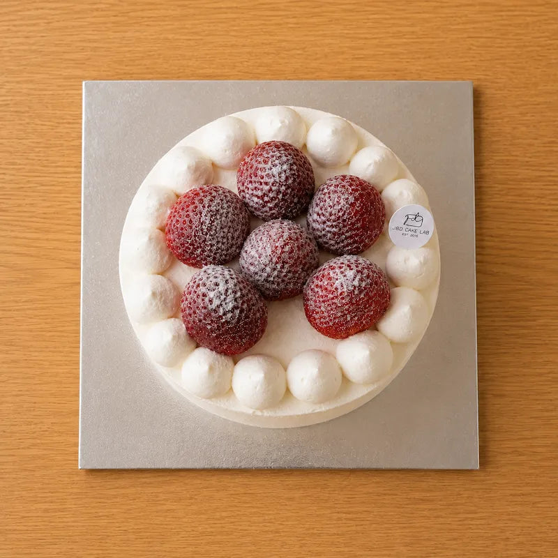 Top view of Japanese strawberry cream cake decorated with whole strawberries