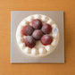 Top view of Japanese strawberry cream cake decorated with whole strawberries