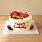 Front view of personalised heart message cake with seasonal fruit and smooth cream finish