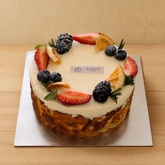 Original Basque Burnt Cheesecake with seasonal berries and citrus decoration in Adelaide