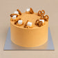 Front view of Thai Tea Velvet cake showing smooth orange cream sides and pretzel-topped cream swirls.