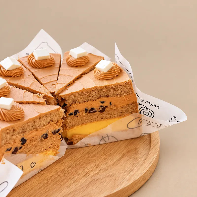 Cut Thai tea cake showing a brown sugar pearl cream filling and a separate yellow pudding layer between sponge layers.