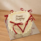Ivory vintage heart birthday cake with red satin bows and pearl piping