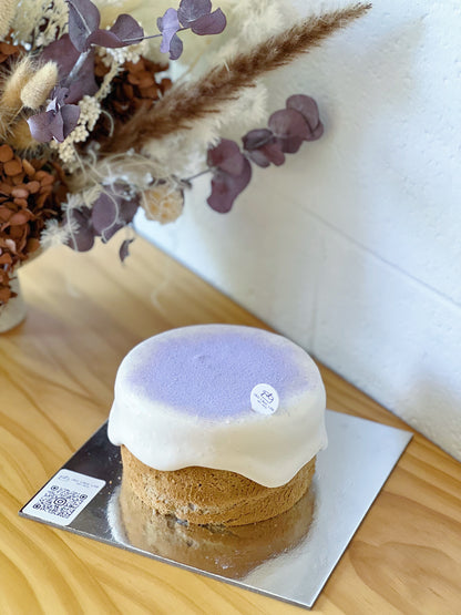High-angle view of a taro cream cheese lava cake with purple taro dusting