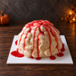 Front view of J&D Cake Lab’s Zombie Brain Halloween Cake with ivory cream piping and dripping red sauce.